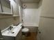 Bathroom with toilet, sink and vanity, and shower over bathtub at 1202 Kilby St, Burlington, NC 27215