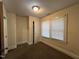 Bedroom with carpeted floors, light-colored walls, closet, and window with blinds at 1202 Kilby St, Burlington, NC 27215