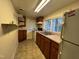 Functional kitchen features a double sink beneath a window, and cabinetry at 1202 Kilby St, Burlington, NC 27215
