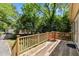Outdoor deck with seating surrounded by a treed yard that is perfect for entertaining at 1304 N Duke St, Durham, NC 27701