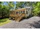 Backyard that includes a deck and a gravel drive/path with well maintained lawn and landscaping at 1304 N Duke St, Durham, NC 27701