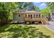 Beautiful backyard with a deck, lush lawn, and landscaping that is perfect for entertaining at 1304 N Duke St, Durham, NC 27701