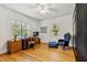 Versatile bedroom with hardwood floors, ample lighting, and a comfortable chair at 1304 N Duke St, Durham, NC 27701