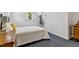 Cozy bedroom with natural light, neutral walls, and gray carpeting plus wood furniture at 1304 N Duke St, Durham, NC 27701