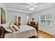 Comfortable bedroom featuring hardwood floors, ceiling fan, dresser, and neutral color palette at 1304 N Duke St, Durham, NC 27701