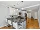 Open kitchen with bar stool seating, stainless steel appliances and fixtures, and pendant lighting at 1304 N Duke St, Durham, NC 27701
