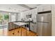 Modern kitchen with stainless steel appliances, gray cabinets and hardwood flooring, adjacent to glass paneled doors at 1304 N Duke St, Durham, NC 27701