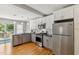Bright kitchen boasts stainless steel appliances, white cabinets, granite counters, and deck access at 1304 N Duke St, Durham, NC 27701