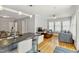 Open floor plan kitchen and living room, with stainless sink and hardwood flooring at 1304 N Duke St, Durham, NC 27701