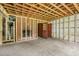 A basement area showing some framing, brick chimney and an exit door at 1407 Arnette Ave, Durham, NC 27707
