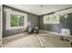 Neutral bedroom primed for renovation with bare walls, offering great light from two windows at 1407 Arnette Ave, Durham, NC 27707