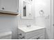 Compact bathroom featuring a white vanity with a sink and built-in storage at 1416 Betz St, Rocky Mount, NC 27803