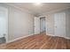 Comfortable bedroom featuring wood-look flooring with views to the ensuite bathroom at 1416 Betz St, Rocky Mount, NC 27803