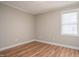 Bright bedroom with wood-look flooring, neutral walls, and a window providing natural light at 1416 Betz St, Rocky Mount, NC 27803