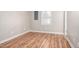 Spacious bedroom featuring wood-look floors, a window, and utility access panel at 1416 Betz St, Rocky Mount, NC 27803