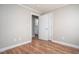 Neutral bedroom with wood-look floors showing an open doorway to another room at 1416 Betz St, Rocky Mount, NC 27803