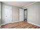 Neutral bedroom with wood-look floors, featuring an open doorway and two closets at 1416 Betz St, Rocky Mount, NC 27803