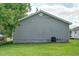 Side view of home showing gray siding, green grass, and utility access at 1416 Betz St, Rocky Mount, NC 27803