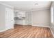Open living area flowing to kitchen with luxury vinyl plank flooring and white cabinetry at 1416 Betz St, Rocky Mount, NC 27803