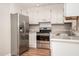 Well-lit kitchen featuring stainless steel appliances, granite countertops, and updated cabinets at 1416 Betz St, Rocky Mount, NC 27803