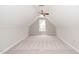 Spacious attic featuring neutral carpeting and a ceiling fan at 1601 Balkan Rd, Fuquay Varina, NC 27526