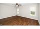 Bedroom with hardwood floors and natural light from two windows at 1601 Balkan Rd, Fuquay Varina, NC 27526