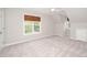 Bright bedroom featuring neutral carpeting, a ceiling fan, and large windows at 1601 Balkan Rd, Fuquay Varina, NC 27526