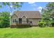Back of house showcasing the deck and green lawn, perfect for outdoor activities at 1601 Balkan Rd, Fuquay Varina, NC 27526