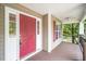 Inviting front porch with a red door and a window with charming red shutters at 1601 Balkan Rd, Fuquay Varina, NC 27526