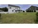 Expansive backyard featuring a white two-story home, a charming screened porch, and a lush green lawn at 170 Kinsale Ct, Garner, NC 27529