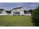 Spacious backyard with a white two-story house, screened porch, and a freshly cut green lawn at 170 Kinsale Ct, Garner, NC 27529