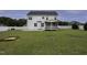 Large backyard showcasing a white two-story home with a screened porch, and a well-manicured lawn at 170 Kinsale Ct, Garner, NC 27529