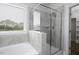 This bathroom showcases a tiled shower and tub, complete with a glass enclosure and window at 170 Kinsale Ct, Garner, NC 27529