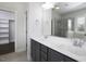Bathroom features double sink vanity, large mirror, and tiled shower with glass door at 170 Kinsale Ct, Garner, NC 27529