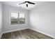 This bedroom offers natural light and neutral paint, showcasing the modern flooring and ceiling fan at 170 Kinsale Ct, Garner, NC 27529