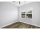 This bedroom offers natural light and neutral paint, showcasing the modern flooring and ceiling fan at 170 Kinsale Ct, Garner, NC 27529