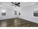 Spacious bedroom with ample natural light from three windows and hardwood floors at 170 Kinsale Ct, Garner, NC 27529
