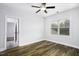 Neutral bedroom with wood-look floors, a window for natural light, and door to an en-suite at 170 Kinsale Ct, Garner, NC 27529