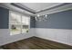 Dining room featuring dark wood floors, neutral walls, and a modern chandelier at 170 Kinsale Ct, Garner, NC 27529