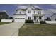 Charming two-story home featuring a white exterior, covered porch, and well-manicured lawn and a two car garage at 170 Kinsale Ct, Garner, NC 27529