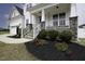 Inviting front porch with stone accents, white railings, and manicured landscaping at 170 Kinsale Ct, Garner, NC 27529