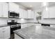 Bright kitchen featuring granite countertops, stainless steel appliances, white cabinetry, and subway tile backsplash at 170 Kinsale Ct, Garner, NC 27529