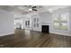 Bright open-concept living room featuring hardwood floors, fireplace, ceiling fan and coffered ceilings at 170 Kinsale Ct, Garner, NC 27529
