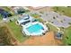 Aerial view of a community pool with lounge chairs, playground, and ample parking at 170 Kinsale Ct, Garner, NC 27529