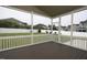 Screened porch with a view of the backyard, white vinyl fence, and neighbor's homes at 170 Kinsale Ct, Garner, NC 27529