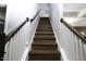 Staircase featuring wooden steps with white risers, and hardwood railing and banister at 170 Kinsale Ct, Garner, NC 27529
