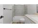 Modern bathroom with gray tiles, shower and tub combo and granite countertop at 1801 Sagamore Ct, Raleigh, NC 27604