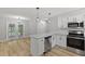 Open-concept kitchen with stainless steel appliances and easy access to outdoor dining at 1801 Sagamore Ct, Raleigh, NC 27604