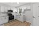 Modern kitchen with stainless steel appliances, white cabinets, and granite countertops at 1801 Sagamore Ct, Raleigh, NC 27604