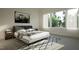 Bright bedroom with large windows, neutral tones, and a comfortable bed with stylish linens and artwork at 1804 Pershing Rd, Raleigh, NC 27608
